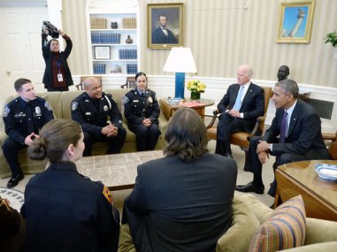 President Barack Obama and Vice President Joe Biden meet with rank-and-file law enforcement officials in the Oval Office of the White House on Feb. 24, 2015, in Washington. (Photo by Olivier Douliery-Pool/Getty Images)